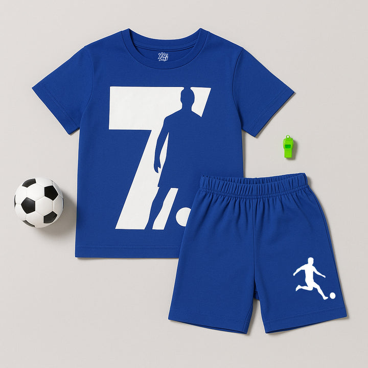 Blue kids’ soccer T-shirt and shorts set with football print, displayed with a small soccer ball and green whistle.