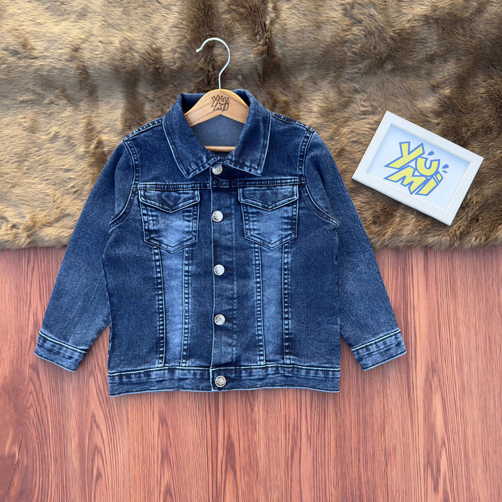 Blue denim jacket on a wooden hanger with a fur rug and card in the background
