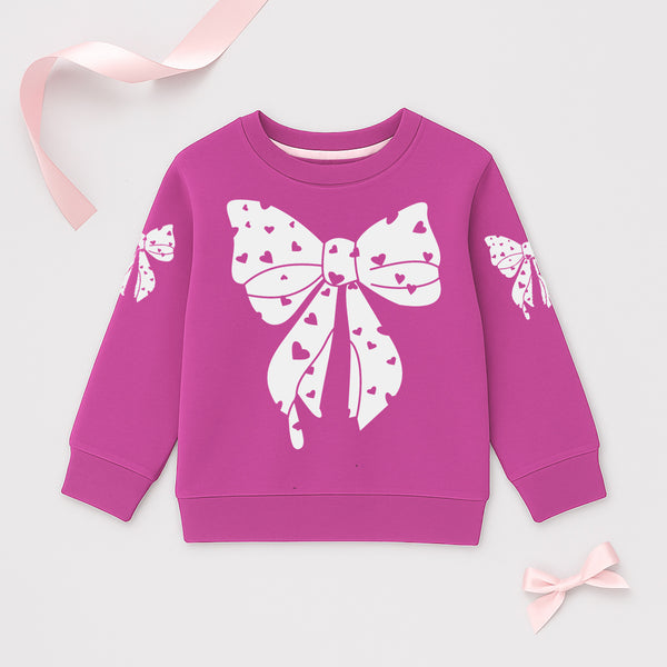 Pink girls’ sweatshirt with white heart bow print on front and sleeves
